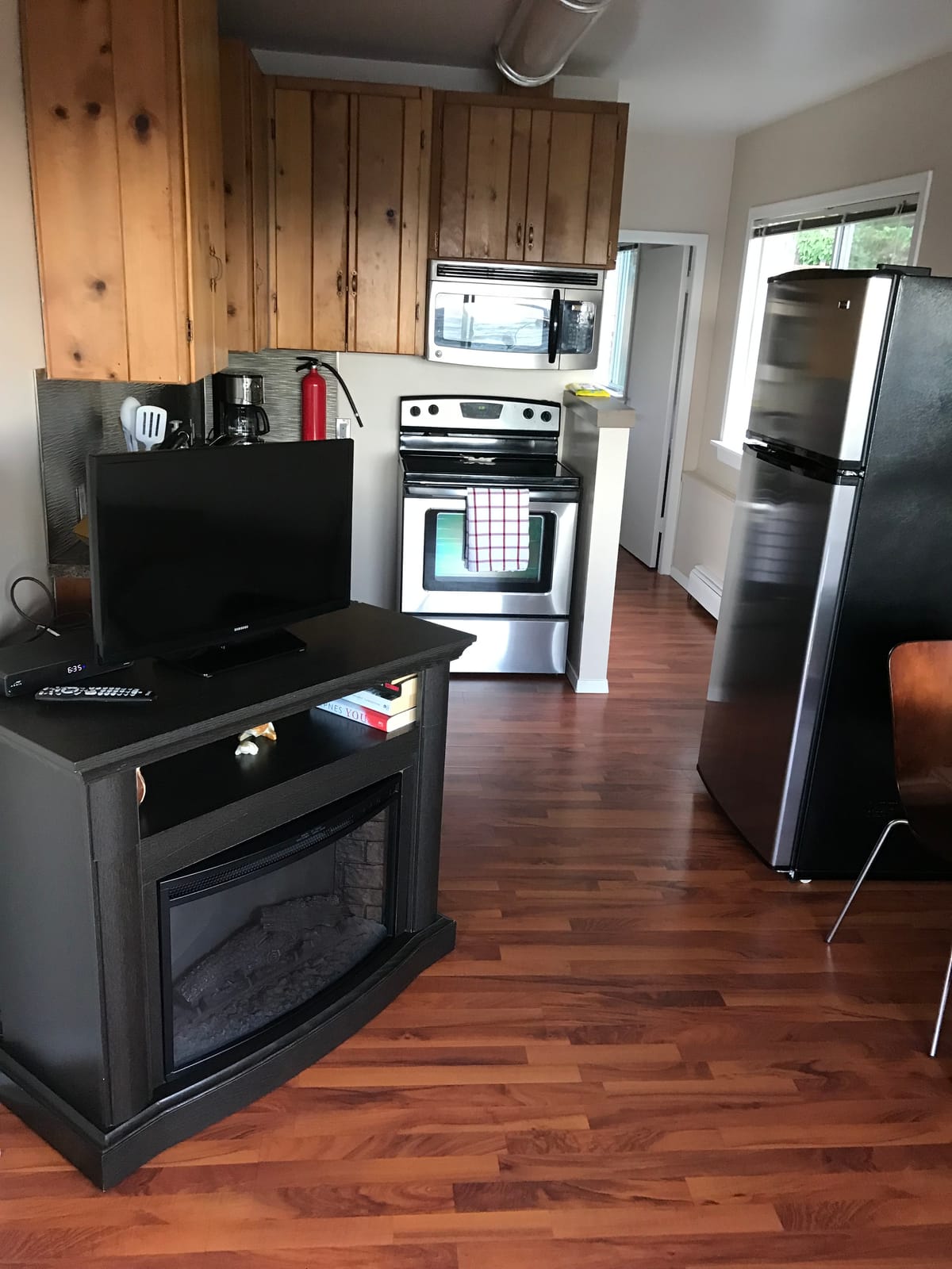 Full kitchen with knotty pine cabinets and stainless appliances